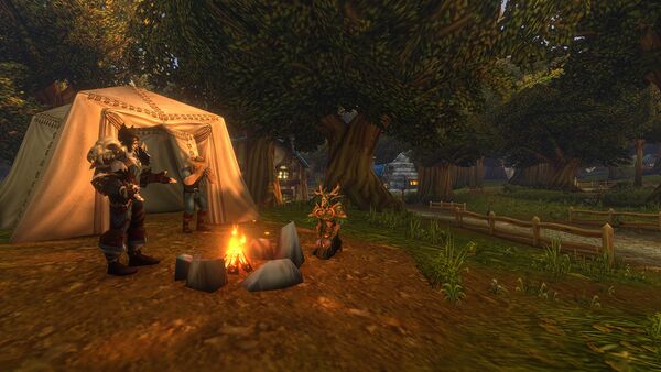 Characters gathered around a campfire beside a tent under trees.